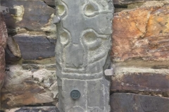 This central portion of a small slab is all that remains of a memorial found in the churchyard: substantial parts of both edges have been lost. The stone bears an equal-limbed ‘Celtic’ cross supported on a ring